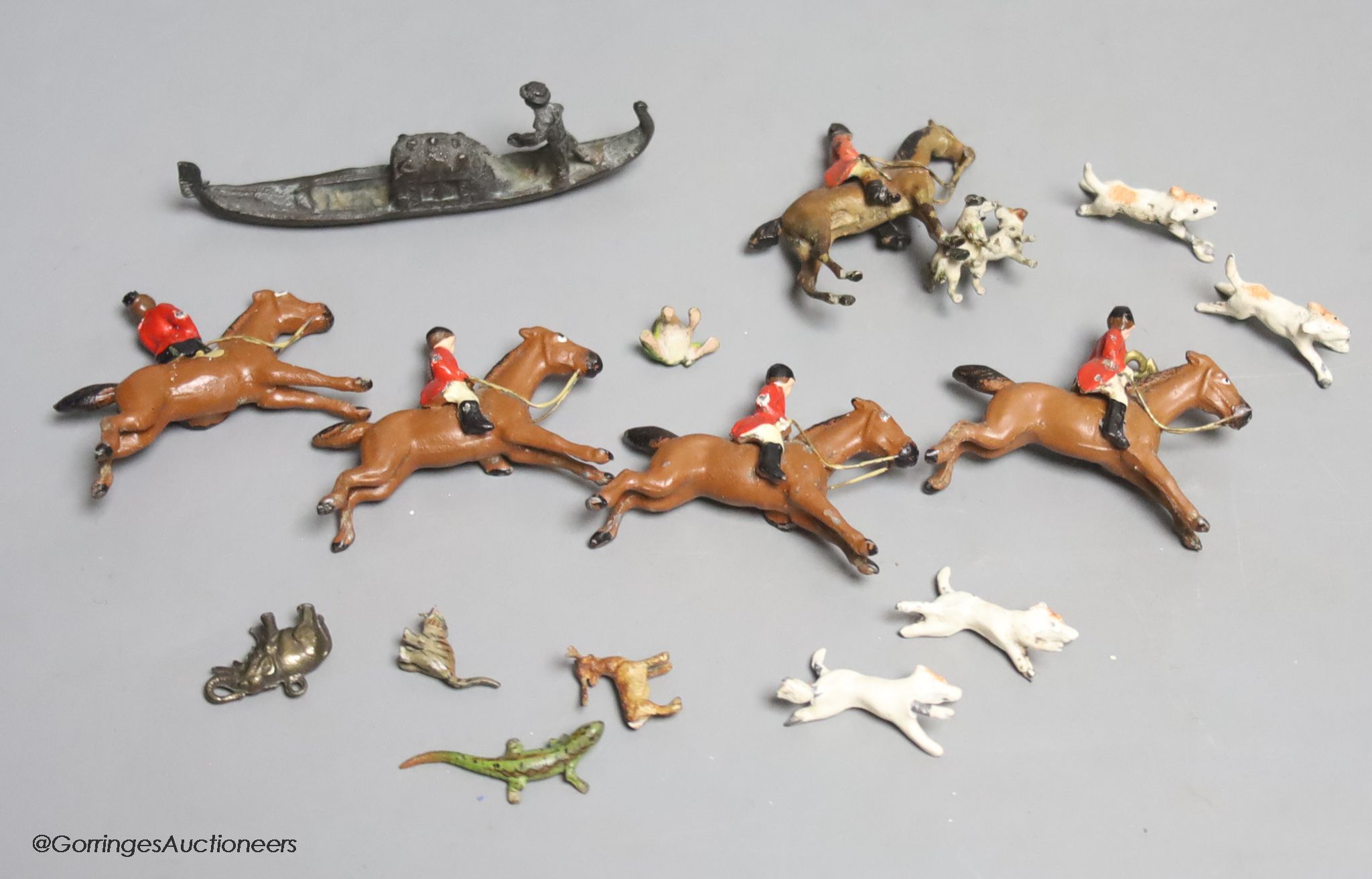 Four miniature cold-painted bronze animals, lizard, stag, frog and cat, a lead part hunting set, an elephant charm and a miniature bronze gondola